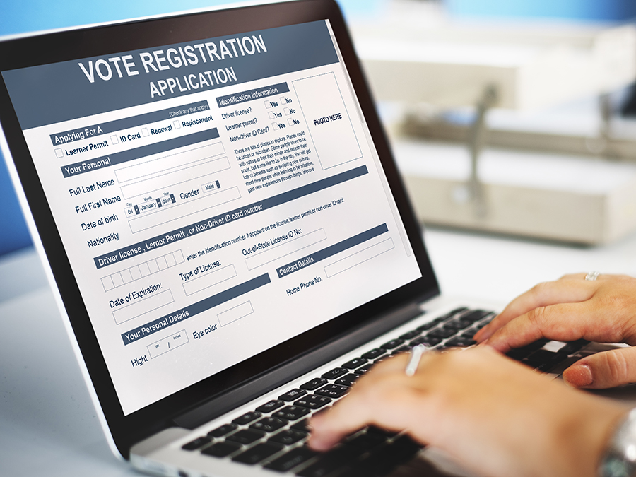 Voter registration page on a laptop screen